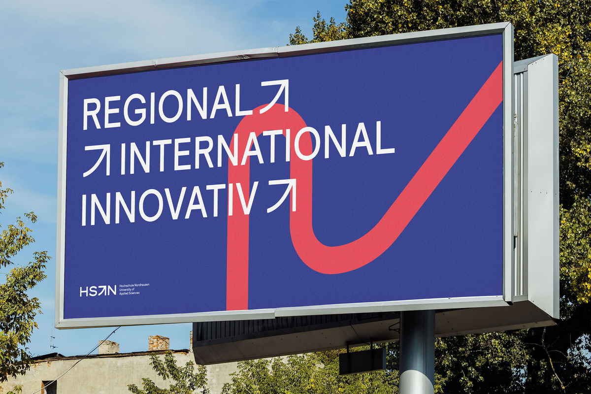 Billboard in front of trees showing with applied new visual identity