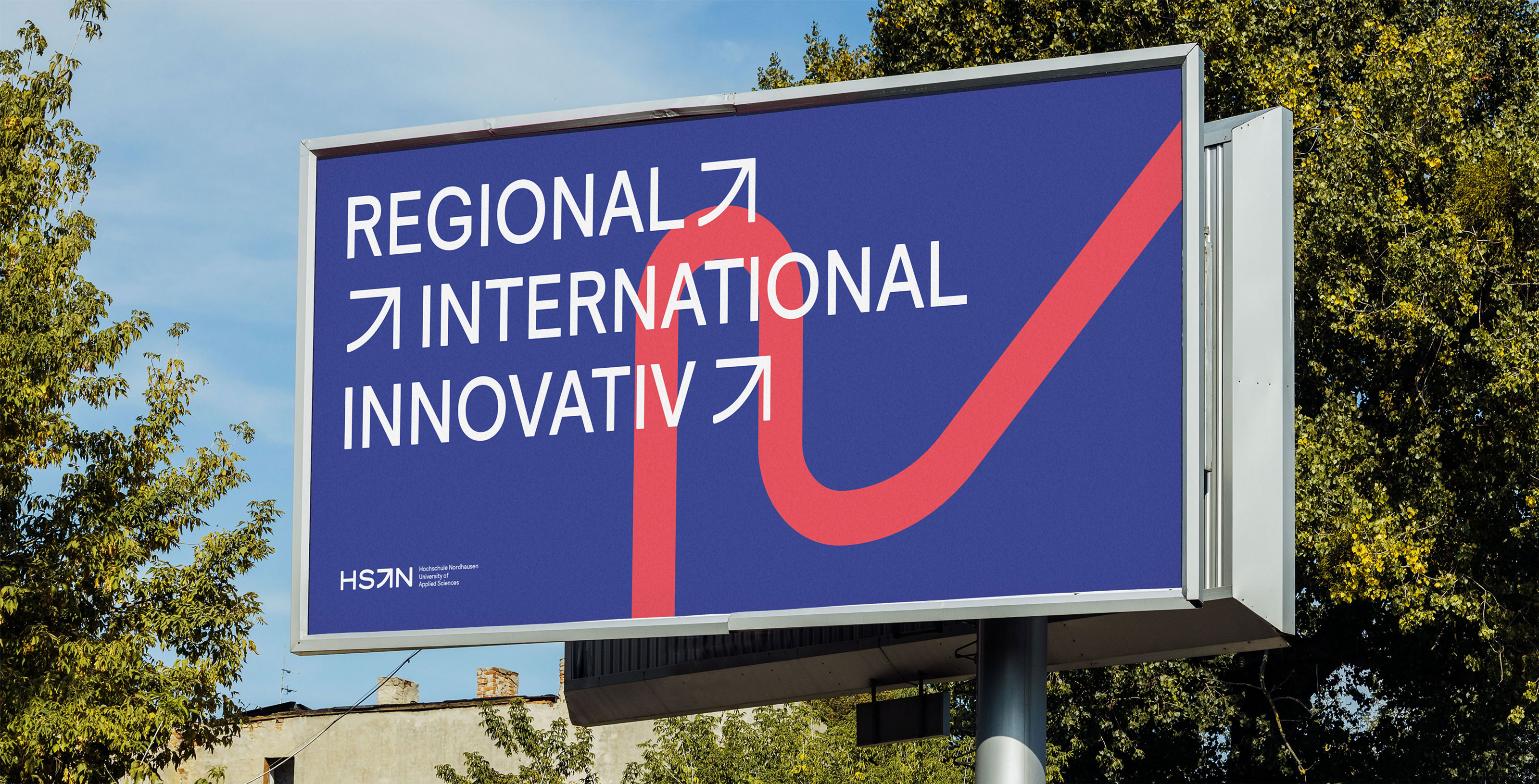 Billboard in front of trees showing with applied new visual identity