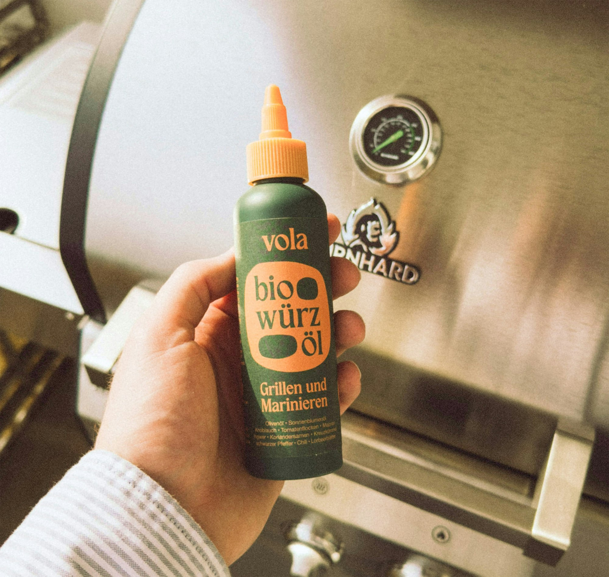 Photography of the face of the spice oil in front of a barbecue