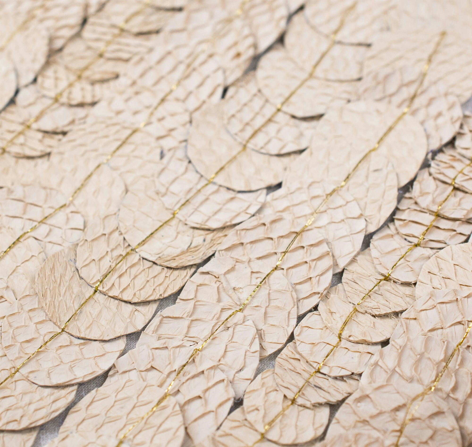 Close-up photography of alternative leather scales in beige.