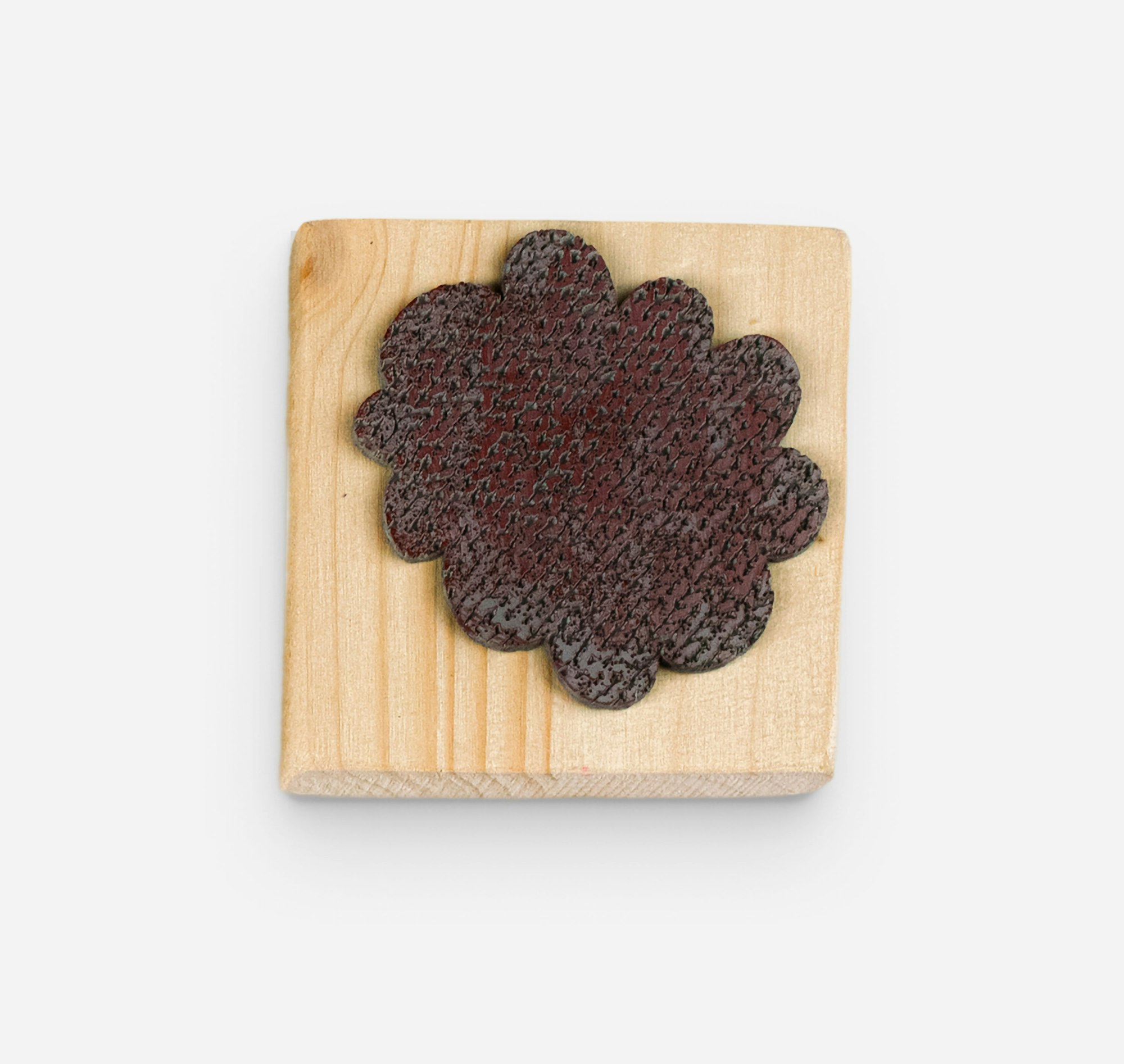 Wooden stamp based on shape found in the visual identity