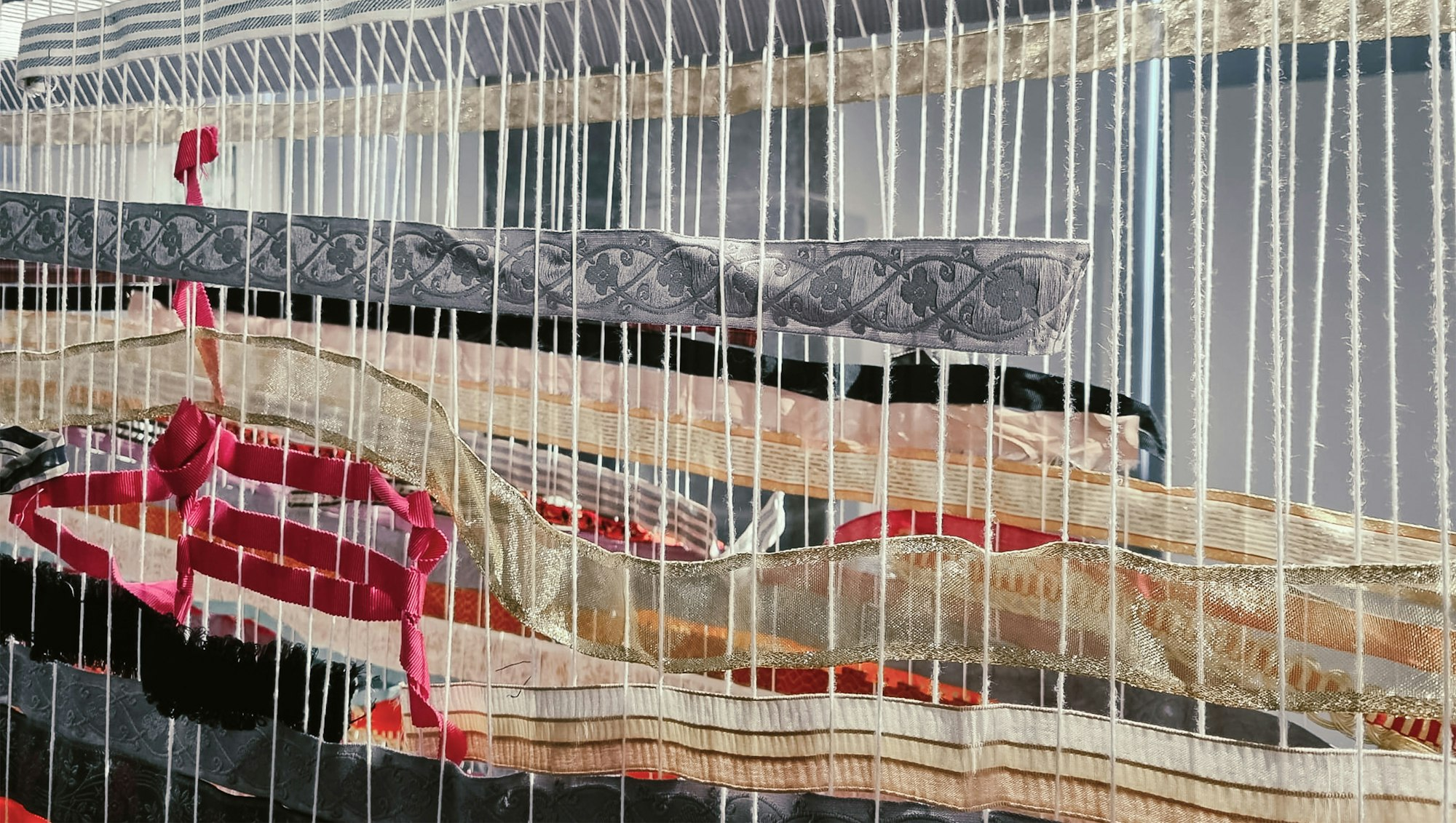 Woven threads that were integrated by visitors as part of an interactive exhibition.